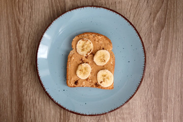 Toast with peanut butter, banana and cinnamon. Top view.