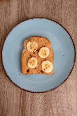 Toast with peanut butter, banana and cinnamon. Top view.