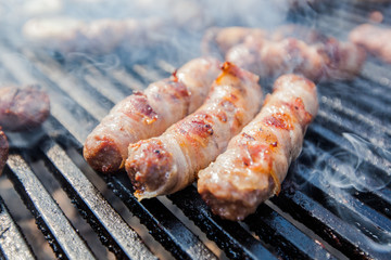 Delicious rolled meat with bacon on BBQ party .