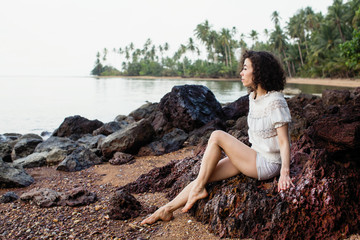 Young asian woman on the coast of a tropical sea beach.