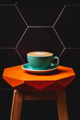Cappuccino. Cup of Cappuccino Coffee on orange table
