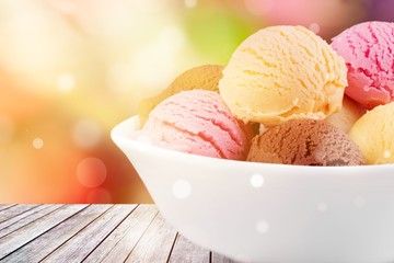 Ice cream scoops in bowl on white background