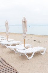 Fototapeta na wymiar deck chairs and umbrellas on the beach