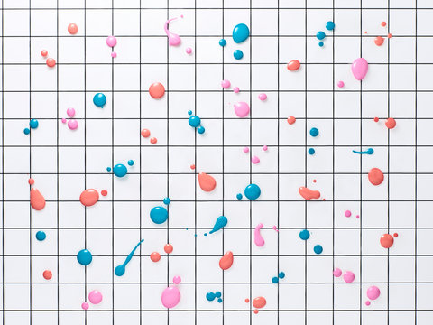 Colorful drops of nail polish on black and white grid