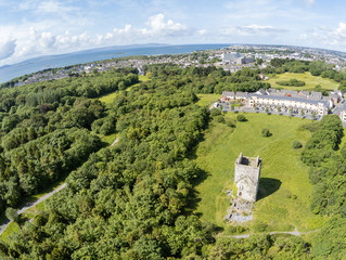 Aerial view of Merlin Castle ruins in Merlin Park with city in background