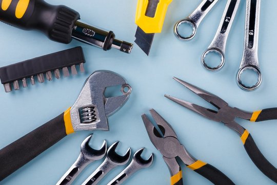 Hand tools kit on blue background. Flat lay.