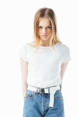 Fototapeta premium upset and offended teenage girl looking at camera isolated on white