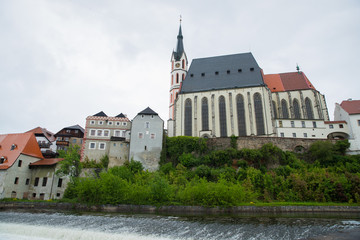 Fototapeta na wymiar Panoramic landscape view of the historic city of Cesky Krumlov with famous Church city is on a UNESCO World Heritage Site captured during spring with nice sky and clouds