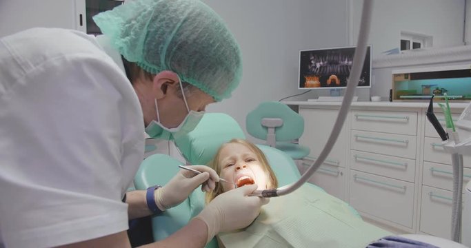 Little girl at visit in the dentist office