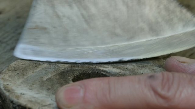 man sharpens ax sharpening close to