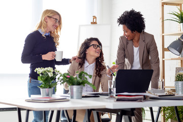 Three multiethnic woman working at the office