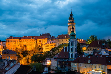 Fototapeta premium Panoramic landscape view of the historic city of Cesky Krumlov during sunset with famous Cesky Krumlov Castle, Church city is on a UNESCO World Heritage Site captured during spring