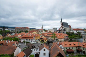Fototapeta na wymiar Panoramic landscape view of the historic city of Cesky Krumlov with famous Church city is on a UNESCO World Heritage Site captured during spring with nice sky and clouds