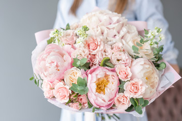 Two Small Beautiful bouquets of mixed flowers in woman hand. Floral shop concept . Beautiful fresh cut bouquet. Flowers delivery