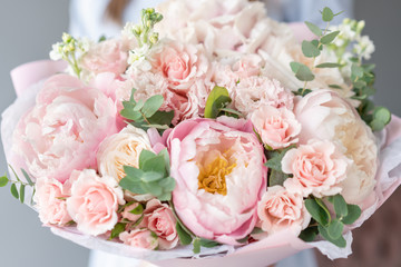 Two Small Beautiful bouquets of mixed flowers in woman hand. Floral shop concept . Beautiful fresh cut bouquet. Flowers delivery