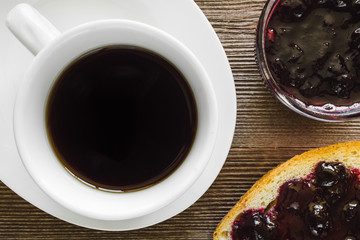 Cup of Coffee with Toast and Jam on Rustic Background