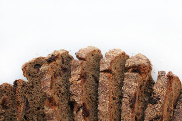Pieces of homemade rye bread with cranberries isolated on white background with free space. The view from the top.