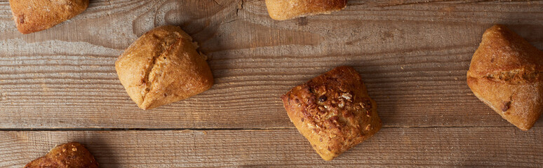 top view of fresh homemade buns on wooden rustic table, panoramic shot