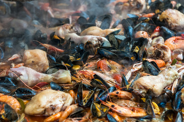 Close up image of paella with seafood and chicken.