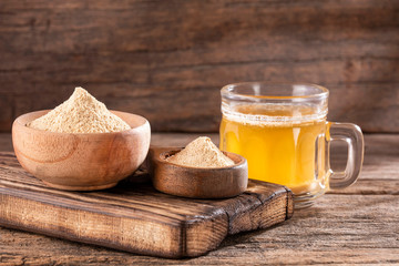 Maca root health drink in a glass with powdered - Lepidium meyenii.