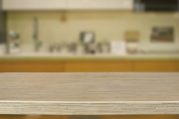 A wooden board on the background of the kitchen. An empty product board. Sharpness in the foreground. Empty space for goods.