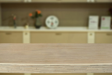 A wooden board on the background of the kitchen. An empty product board. Sharpness in the foreground. Empty space for goods.