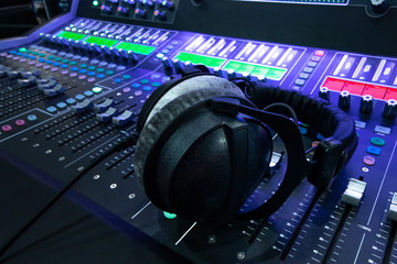 Professional audio studio sound mixer console board panel with recording , headphone and adjusting knobs,TV equipment. Blue tone and close-up image with flare light effect. - 272704258