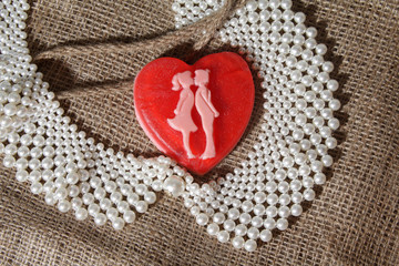 Heart and beads on vintage background. Romance