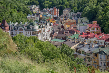 Fototapeta na wymiar Roofs of colorful beautiful houses surrounded by trees. Kiev, Ukraine