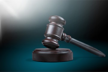 Wooden gavel on wooden table, on  background