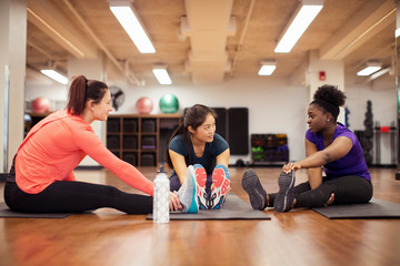 Women talking while exercising in gym