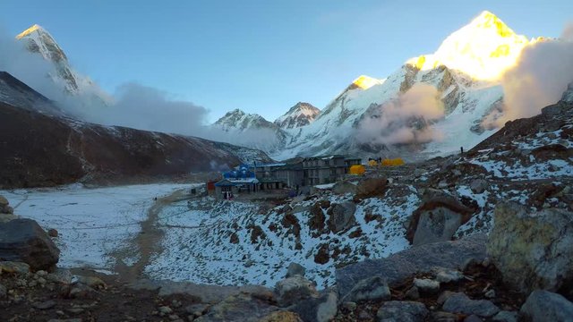 4k time lapse view of Gorak Shep village at the foot of mountains Pumori, Nuptse and Everest at sunset in Sagarmatha National Park in Nepal. Travel, adventure, hiking and climbing concept.