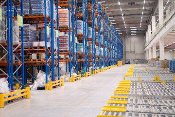 Warehouse storage interior. Large distribution center with shelves loaded with goods.