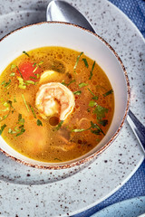 A set of healthy food in plates. Set of food in a cafe - soup and salad on a served table. On a wooden background. Copy space.
