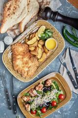 Food concept, table with various snacks placed on it. Salad with salmon, caesar skuric, pickled mushrooms, bread.
