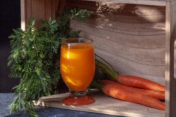 Fresh carrot juice and carrots. Smoothie. Healthy diet concept. Wooden background with copy space.