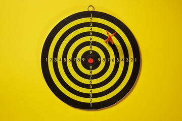 Red arrow dart hitting the target dartboard