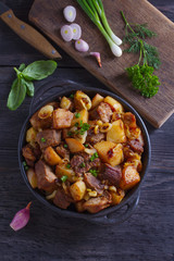 Tasty food: succulent beef with fried potatoes, onion and garlic. Country-style roasted potatoes with meat