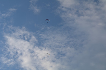 Fototapeta na wymiar kite flying in the sky,motorized,paraglider,sport, blue, fly,adventure, cloud,sports, glider, wind, high, 