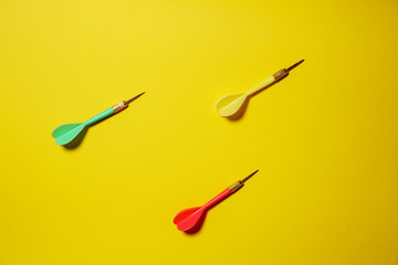 Single yellow, green and red arrows darts isolated on yellow background