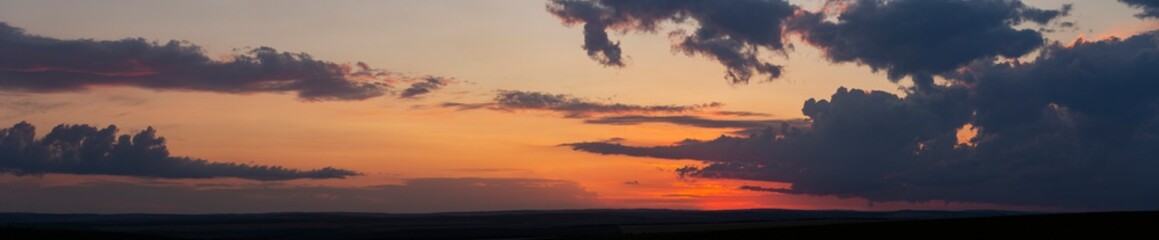 Leaden, storm clouds covered the sunset. Cumuliform cloudscape on blue sky. The terrain in southern Europe. Fantastic skies on the planet earth. Tragic gloomy sky. 