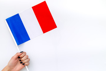 Flag of France in hand on white background top view