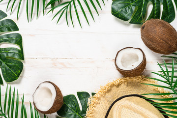 Palm leaves and coconut on whitee top view.