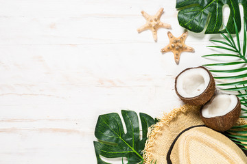 Palm leaves and coconut on whitee top view.