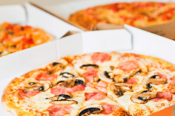 Delicious pizza Margherita with tomatoes and cheese in paper box