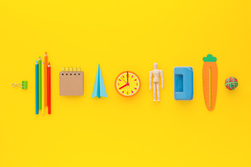 Back to school concept. School accessories on yellow background.