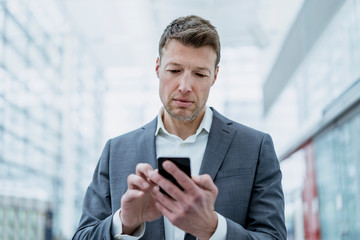 Portrait of businessman using cell phone