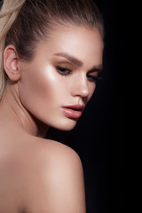 Obraz premium Glamour portrait of beautiful woman model with makeup on black background.
