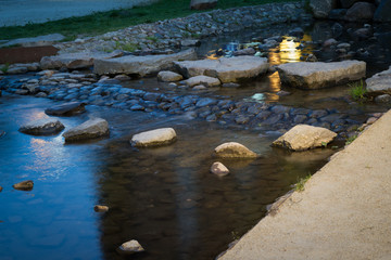 Stone path in a pond at sunset in Garnizon. Gdansk, Poland