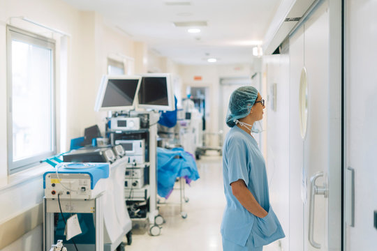 Female doctor standing in hospital corridor, preparing for surgery